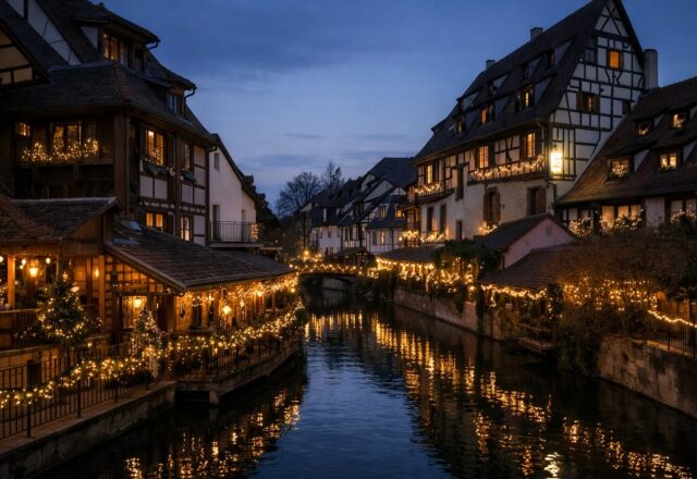 Casas em enxaimel ao longo de um canal com luzes de inverno ao entardecer