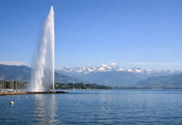 Jato de água no lago com os Alpes nevados ao fundo